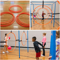 Orange hula hoops on a wooden floor. Hoops attached to 9 Square in the Air game to create targets. Young boy throwing a frisbee through the hoops. Boys and girls tossing pink balls through the hoops. 