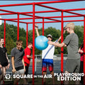 Permanent installation with 15-year warranty. Children smiling while playing game with a red 9 Square in the Air Playground Edition and blue ball with a blue sky and green trees in the background