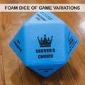 Foam dice of game variations - blue, 14 sided foam dice with different game play variations printed in black on each side on a wooden background. 