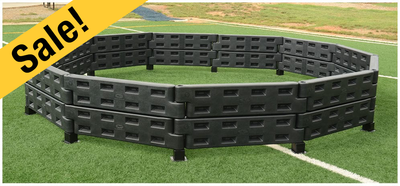 Black gagaball pit on green athletic field 